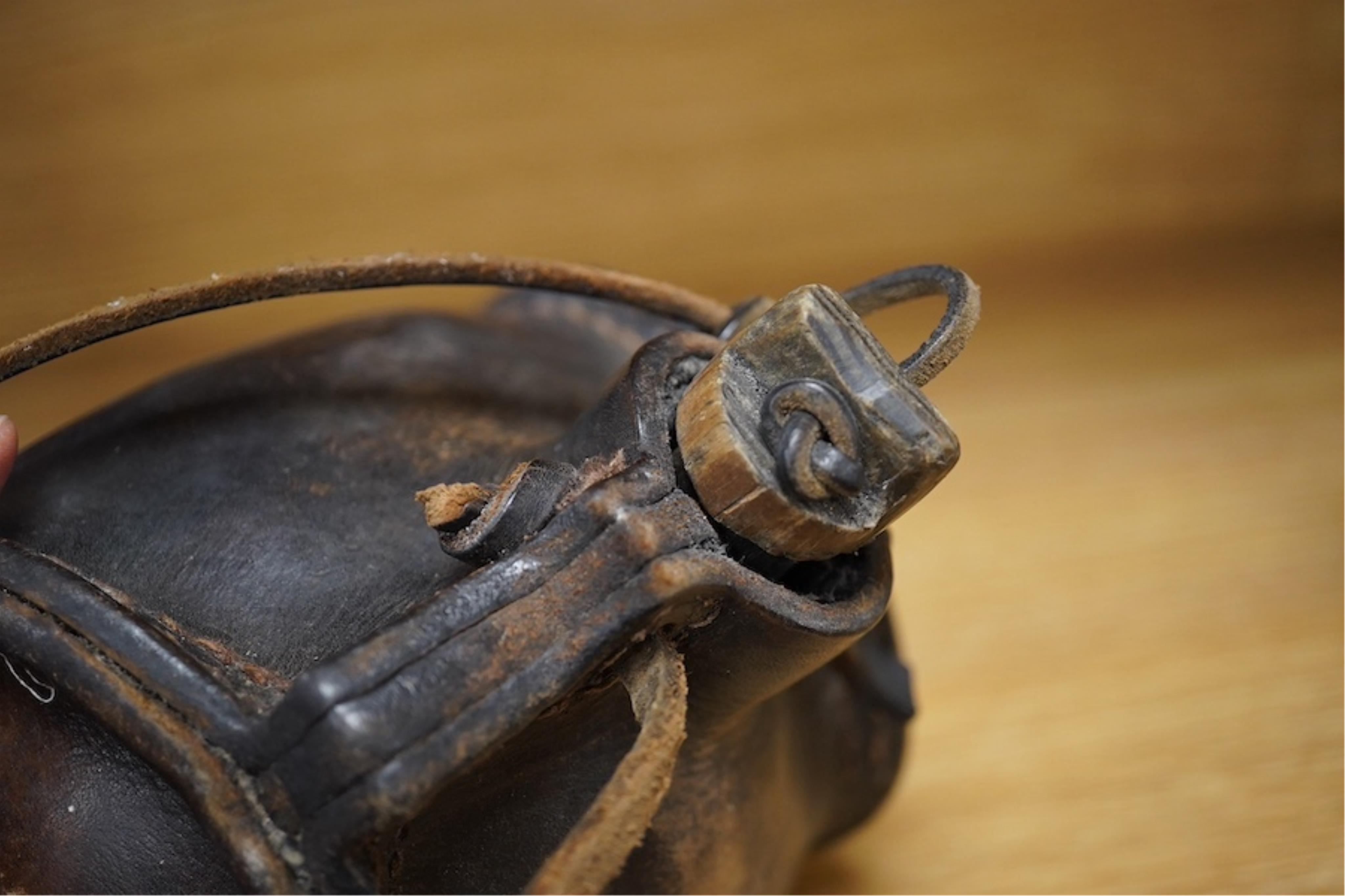 A leather cider costrel, 14cm wide. Condition - fair, some scuffing